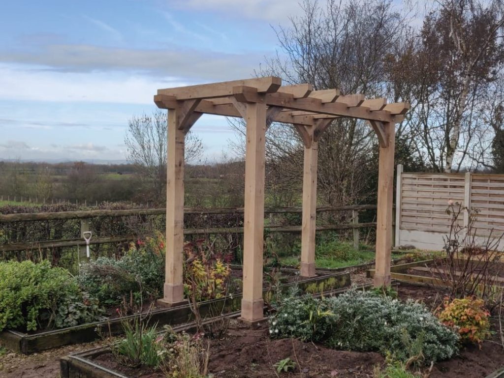 green oak timber framed pergola in garden