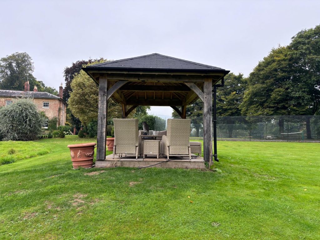 roofed gazebo in garden viewed from the side